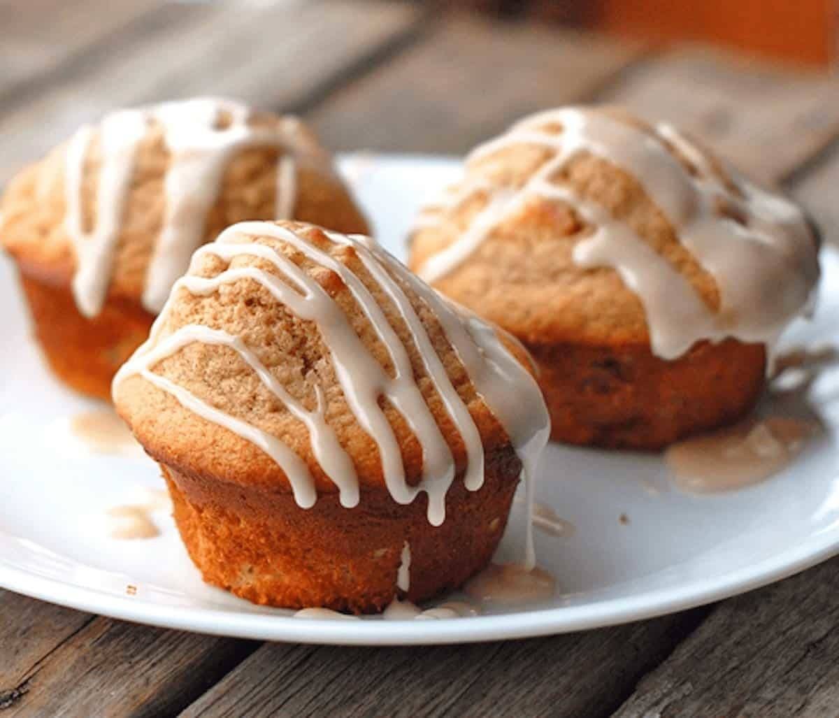 Apple cinnamon muffins topped with a warm vanilla glaze.