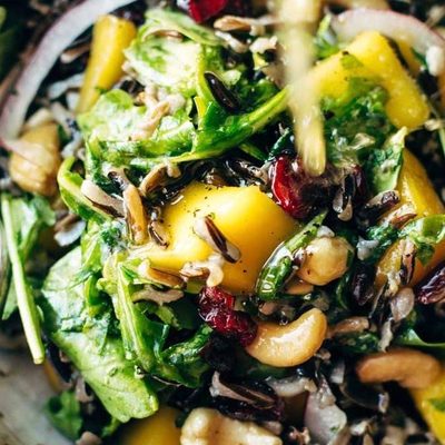 Thanksgiving Salad in a bowl with dressing.
