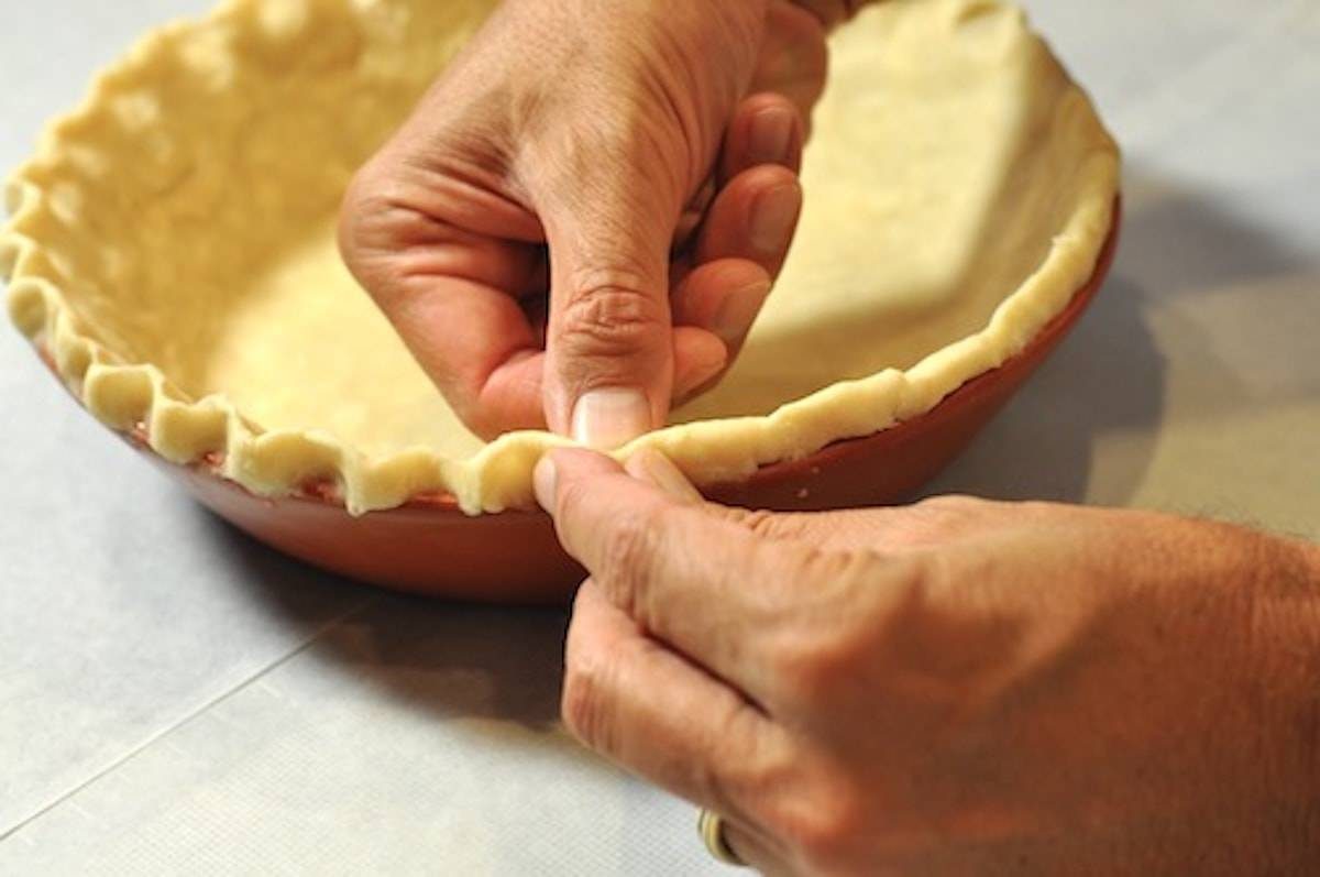 Pinching pie crust.